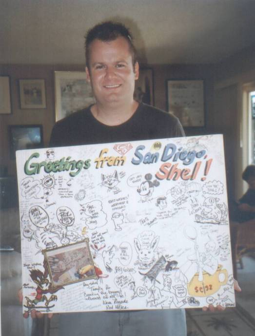 Matt Lorentz holds giant greeting card for Shel Dorf created at Comic-Con 2009 by many artist contributors.